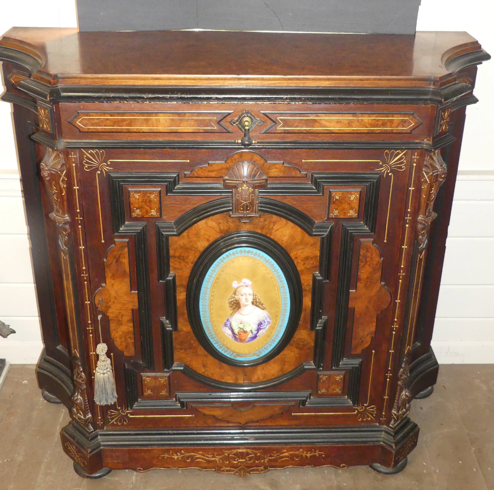 RENAISSANCE REVIVAL CREDENZA - PORTRAIT PLAQUE: Superb 19th century Renaissance Revival walnut credenza with large oval hand painted plaque of a girl (13 x 8.5 in). The credenza has one drawer, and lower compartment with raised moldings having