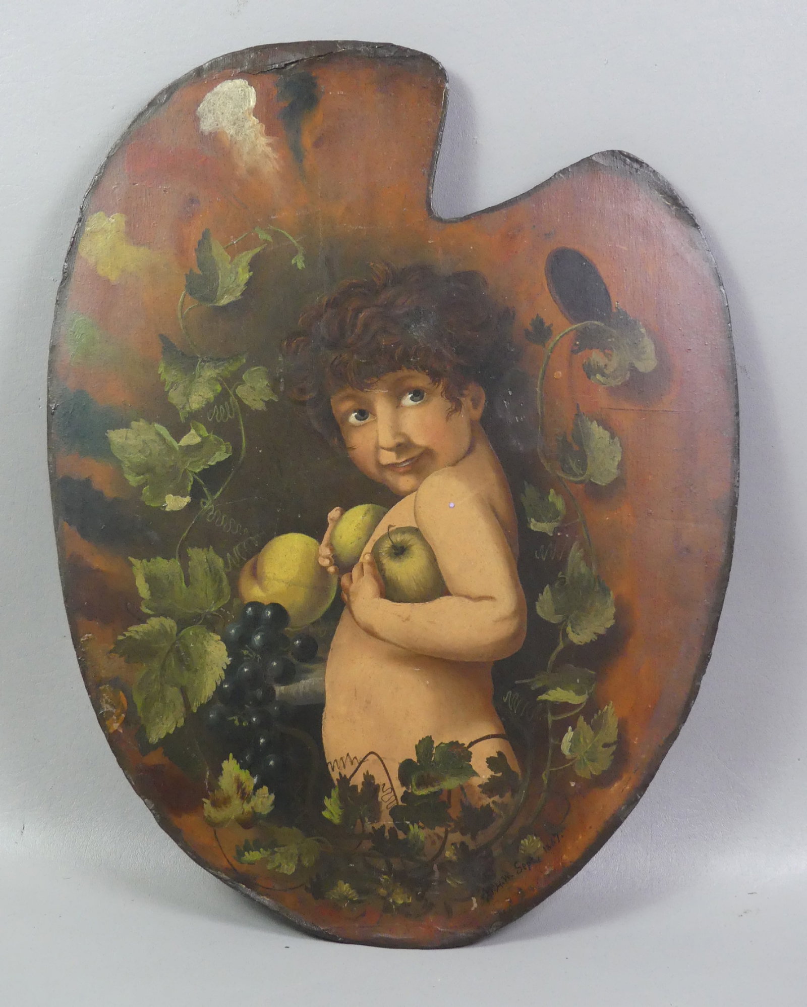 1887 GENRE PALETTE PAINTING - BOY: Victorian oil painting on wood palette depicting a semi-nude boy holding apples under grape arbor, initialed WHW 1887. 20 x 16 in.