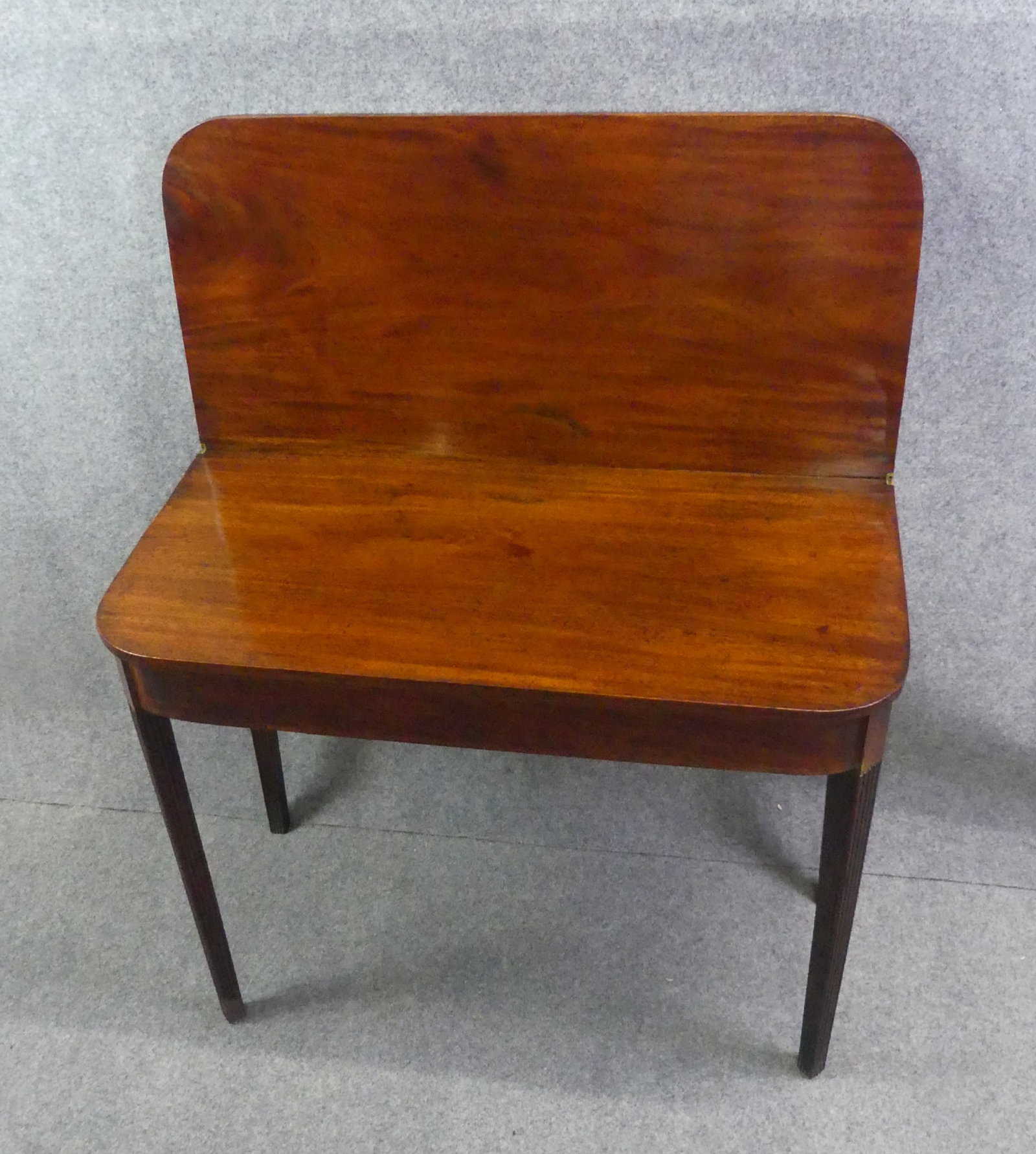 PERIOD HEPPLEWHITE INLAID CARD TABLE: Period American mahogany Hepplewhite card table with fluted legs. 36 in wide x 18 d x 28 in high.