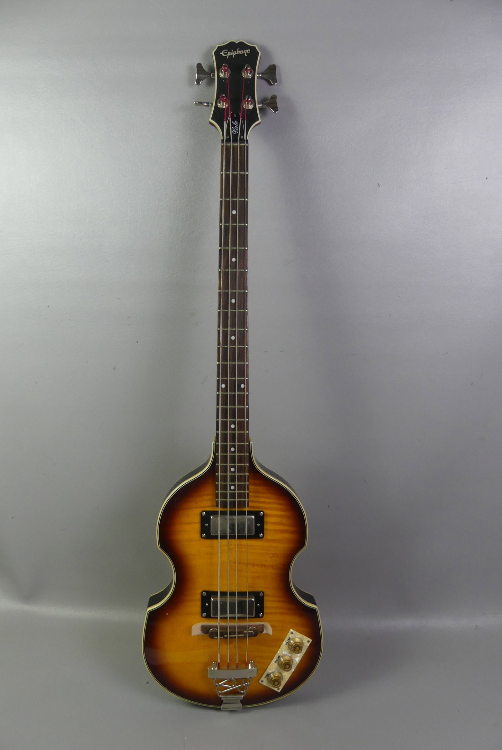 EPIPHONE BASS GUITAR: Vintage Epiphone Viola bass electric guitar with tiger maple body, made in China. 44 in long, serial number 0810202117. VG condition.