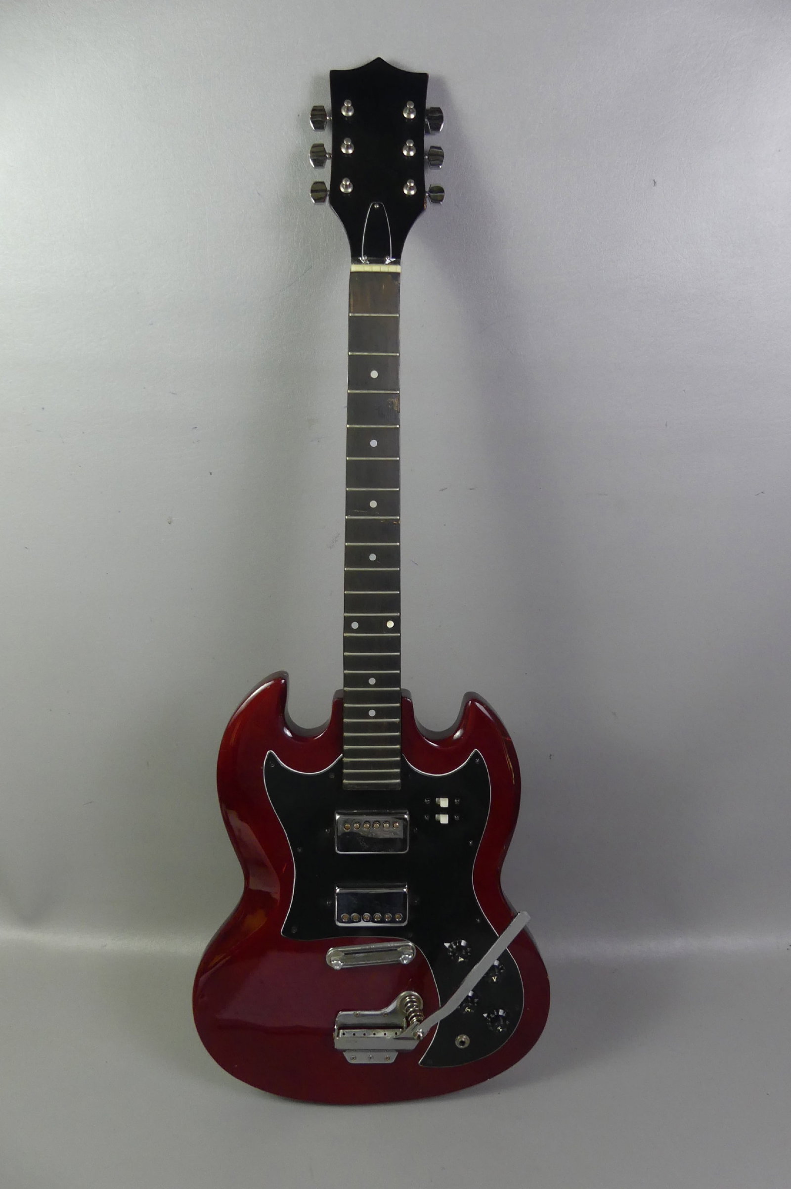 RED 6 STRING ELECTRIC GUITAR: Vintage cherry red electric guitar with whammy bar and 6 strings. 39 in long. No maker name