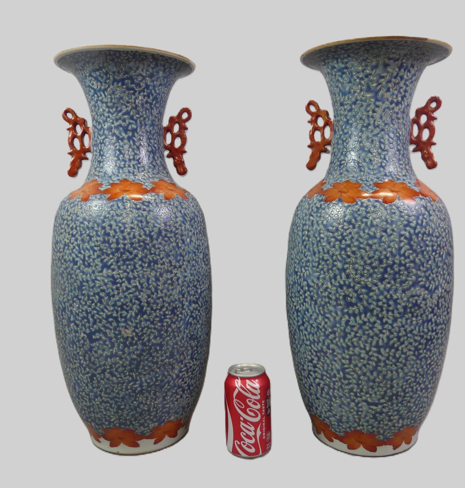 PAIR LARGE CHINESE FAMILLE ROSE VASES: Pair of large 19th century Chinese large porcelain famille rose vases with allover blue swirling floral designs and iron red openwork handles and encircling blossoms. Signed on underside. 22 in tall a