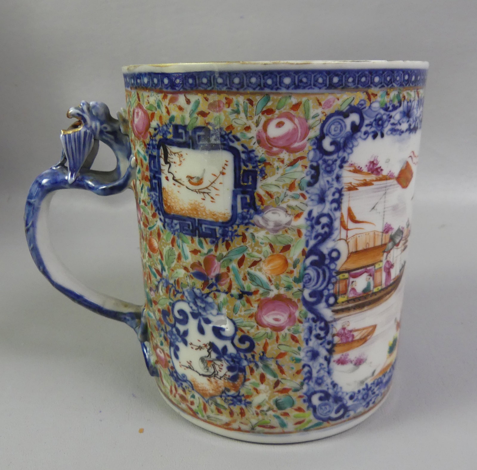 QIANLONG CHINESE LARGE MUG: 18th century Chinese porcelain Qianlong large mug, polychromed decoration of harbor scene with figures and dragon handle. 6 in tall x 5 in diameter. Good condition with small glaze knick/ageline on si
