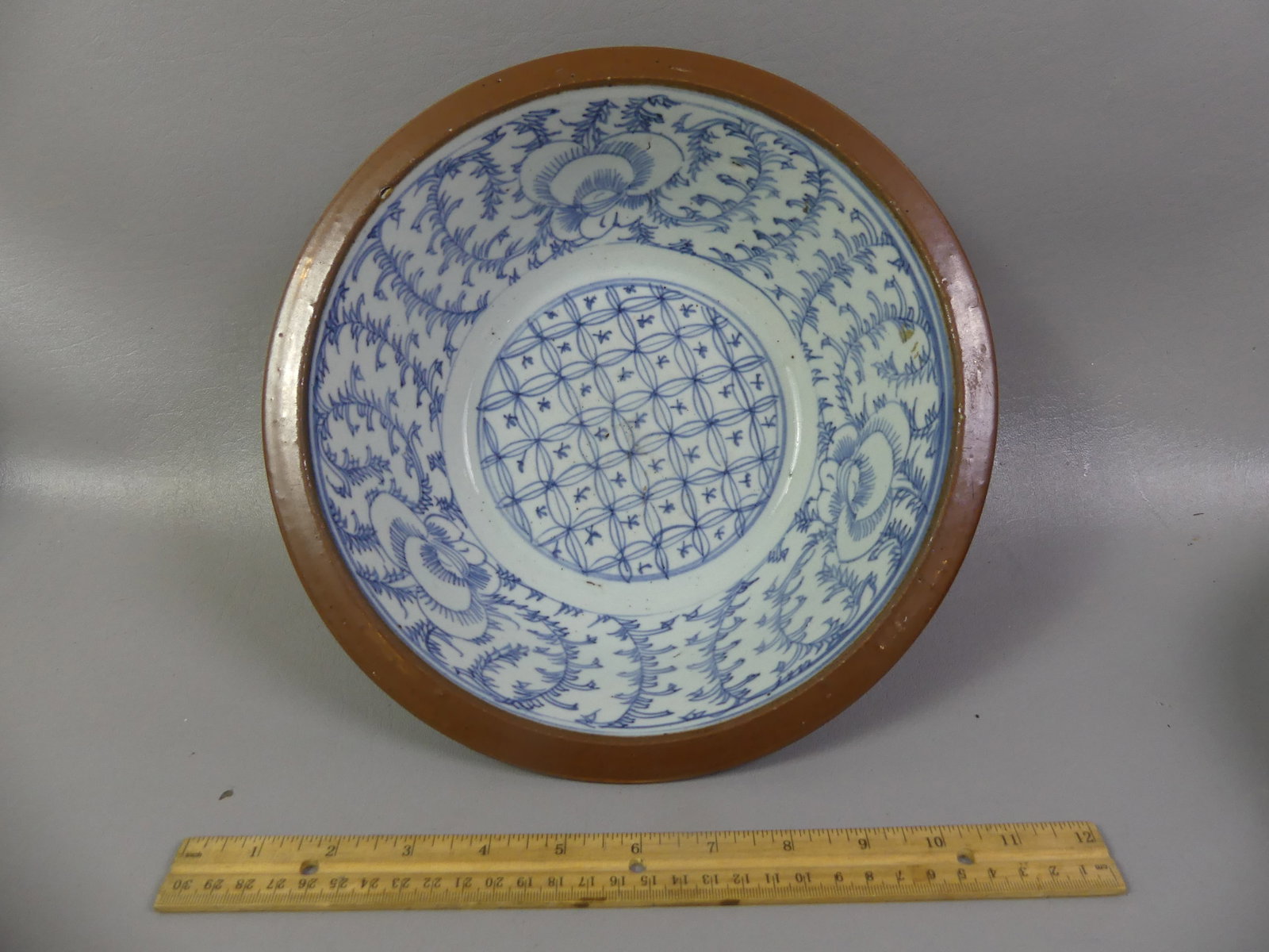 QING CHINESE BATAVIA WARE BOWL: Qing Chinese Export porcelain Batavia Ware bowl with blue and white floral decoration, checkered design on interior and brown glaze exterior. 11 x 3.5 in deep. Circa mid 1800's. VG condition.