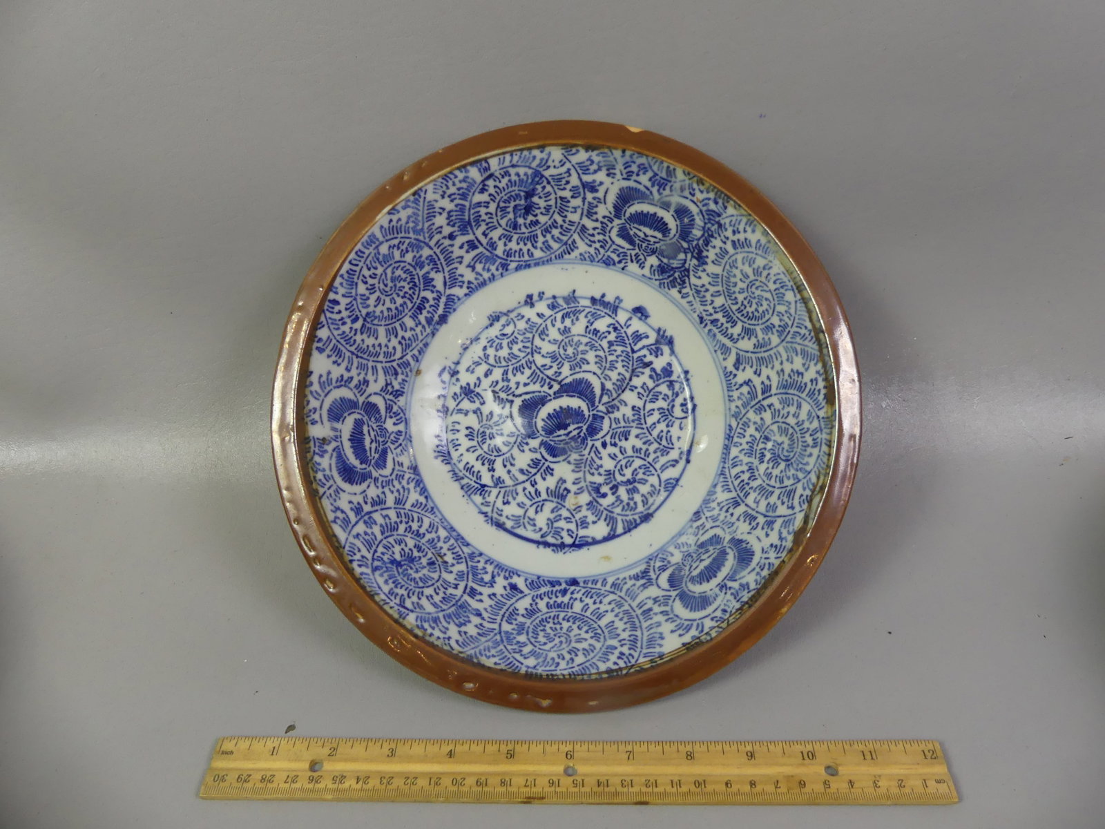 QING CHINESE BATAVIA WARE BOWL: Qing Chinese Export porcelain Batavia Ware bowl with blue and white floral and spiral decoration and brown glaze exterior. 11 x 3 in deep. Circa mid 1800's. Good condition with uneven glaze on rim.