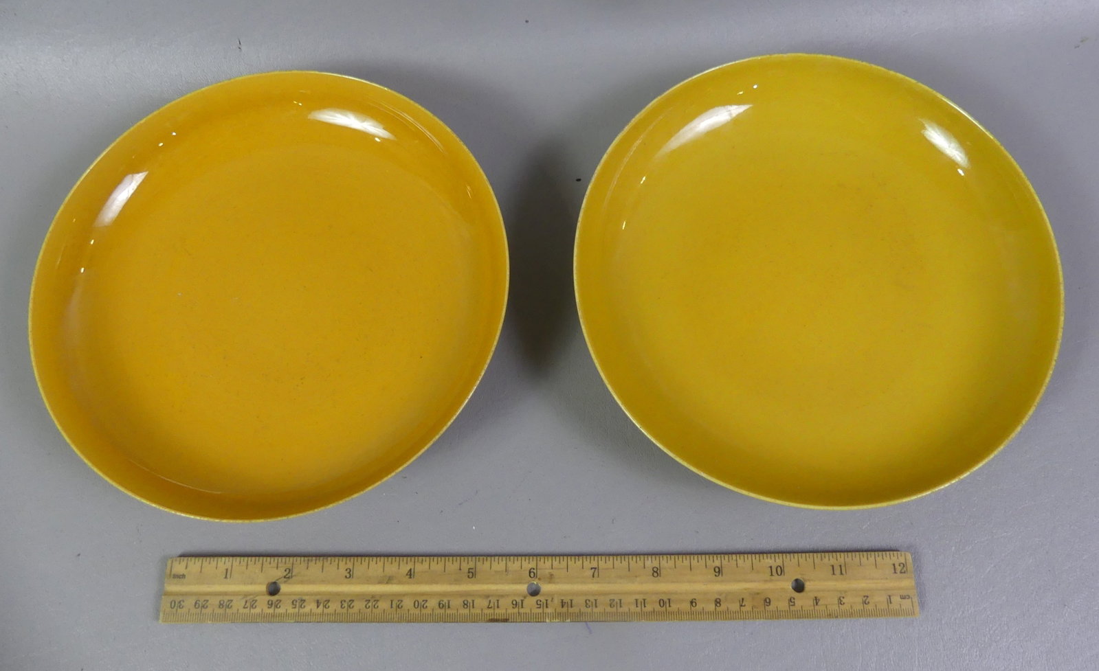PAIR EARLY CHINESE FAMILLE JAUNE PLATES - HONGZHI: Pair of circa late 1800's Chinese Famille Jaune yellow glazed porcelain plates with 6 character Hongzhi mark. 8 in diameter. Both VG condition.