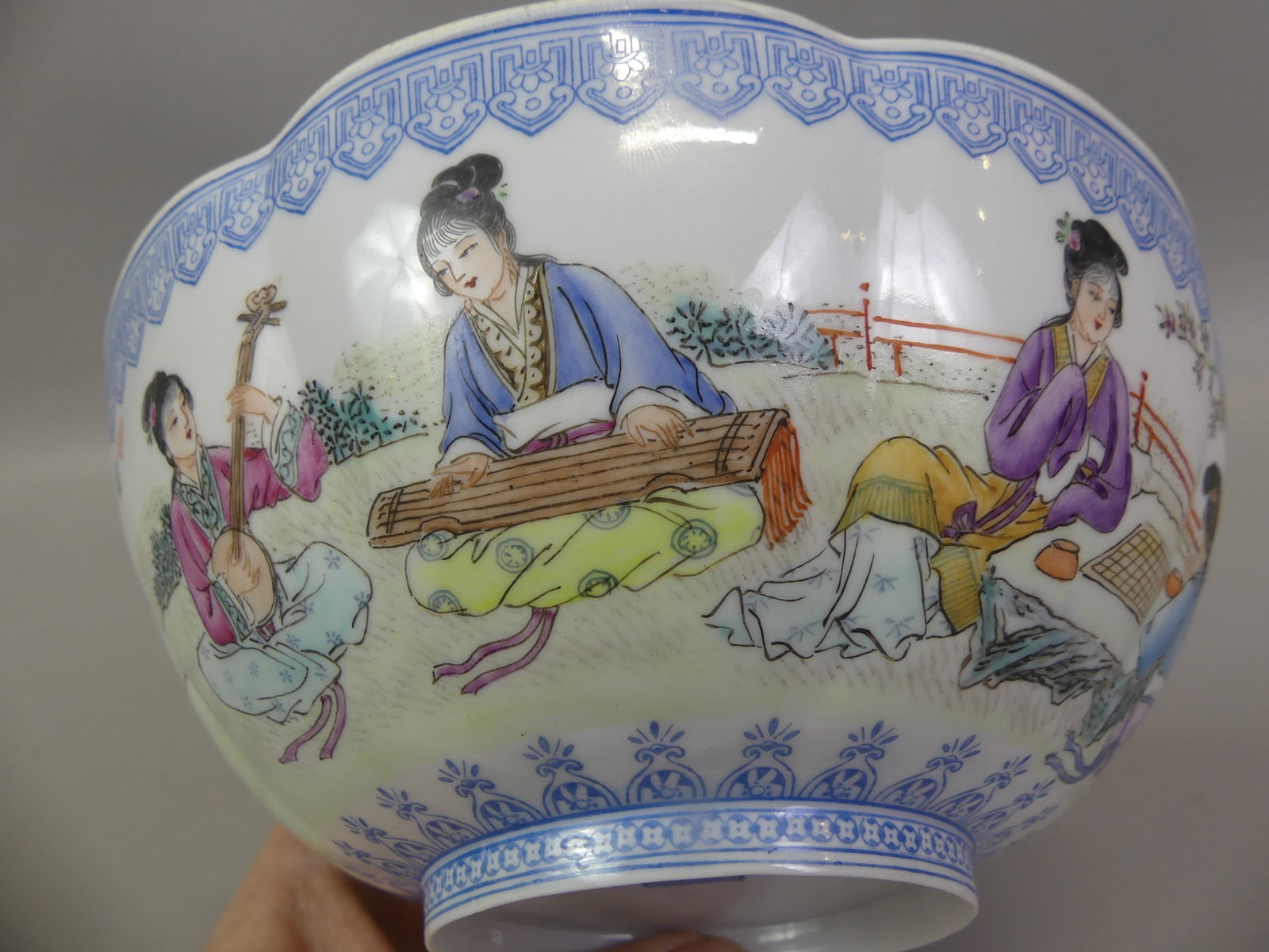 CHINESE EGGSHELL PORCELAIN BOWL - SIGNED: Fine old Chinese porcelain eggshell bowl with painted genre scenes (women playing instruments etc) and calligraphy. Has Qianlong mark on underside, 20th century. 7 in diameter and 2.75 in high.