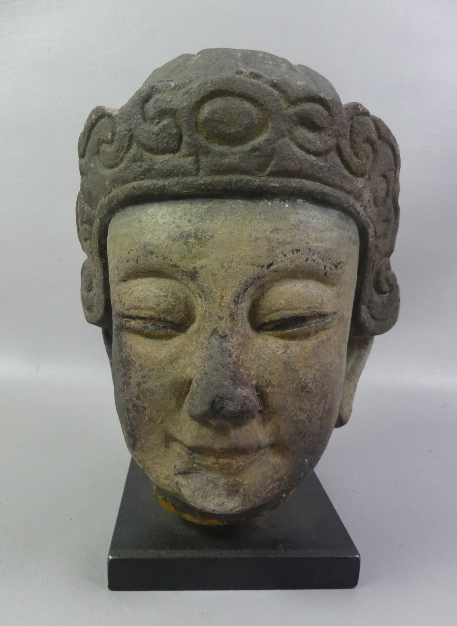 ANCIENT CHINESE BUDDHA HEAD: Ancient Chinese sandstone carved buddha head, probably Guanyin. Has chip on chin. 11 in hig, 6.5 in wide.