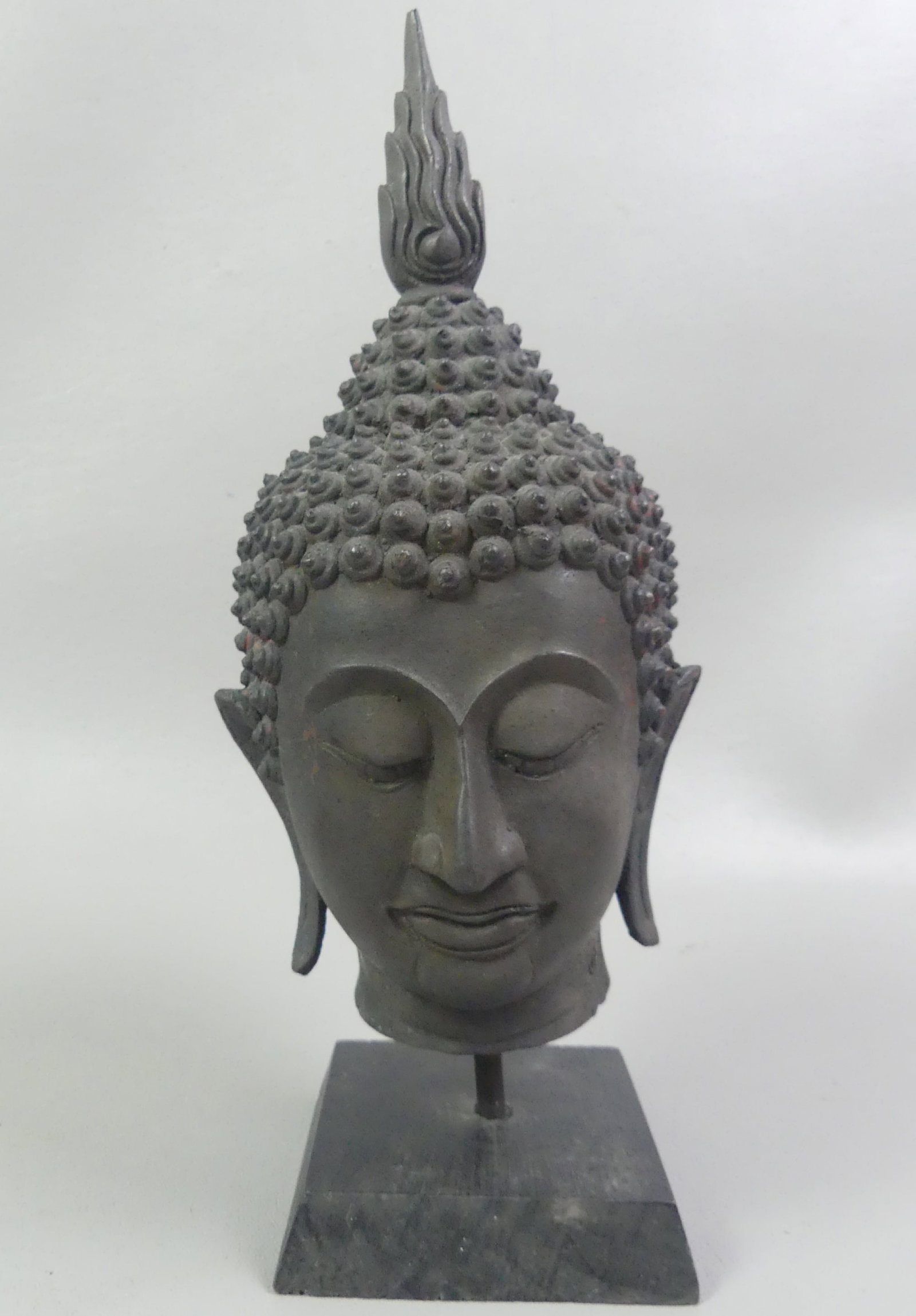 ANTIQUE THAI BUDDHA HEAD: Antique bronze buddha head with blackish patina and modern wood base. Attributed Thailand, probably Sukhothai. 11.5 in high.