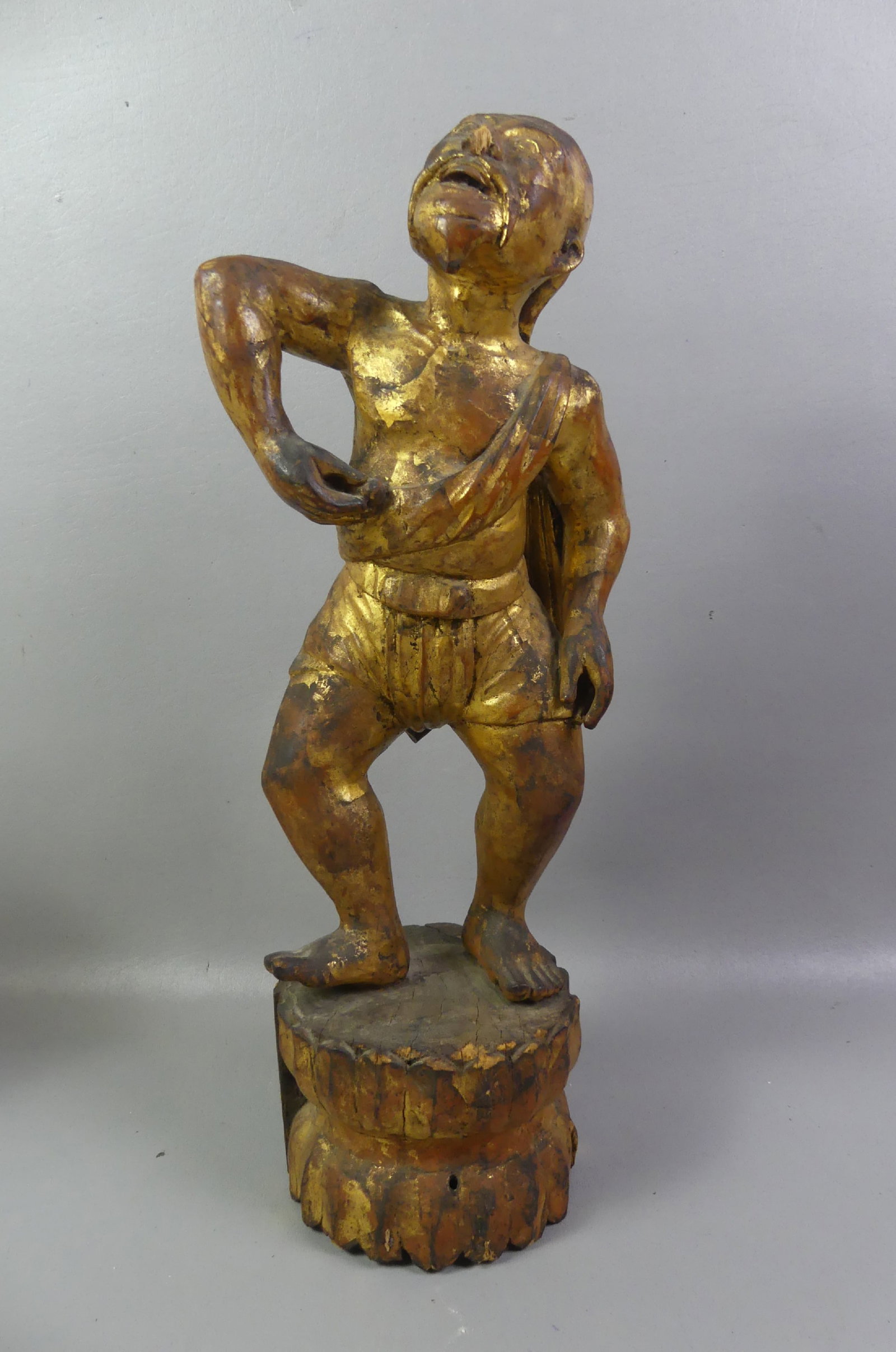ANTIQUE GILTWOOD DANCER ATTR. BURMESE: 19th century gilt wood figure of a devotional dancer attributed Burmese. 20.5 in tall and 6 in wide. Some loss to wood base.