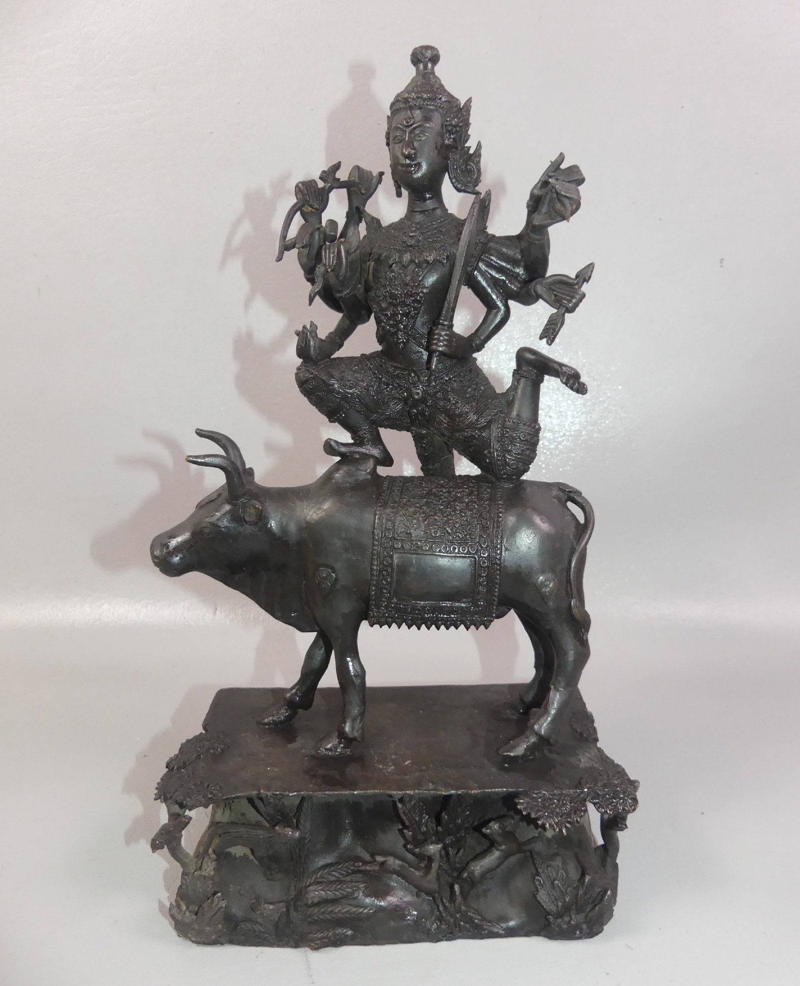 TIBETAN BRONZE NANDI & BULL SCULPTURE: 19th century bronze sculpture of Hindu god Lord Shiva riding the Nandi bull. Base has several animals. Dark patina, 14 in tall x 8 w x 4.5 deep.