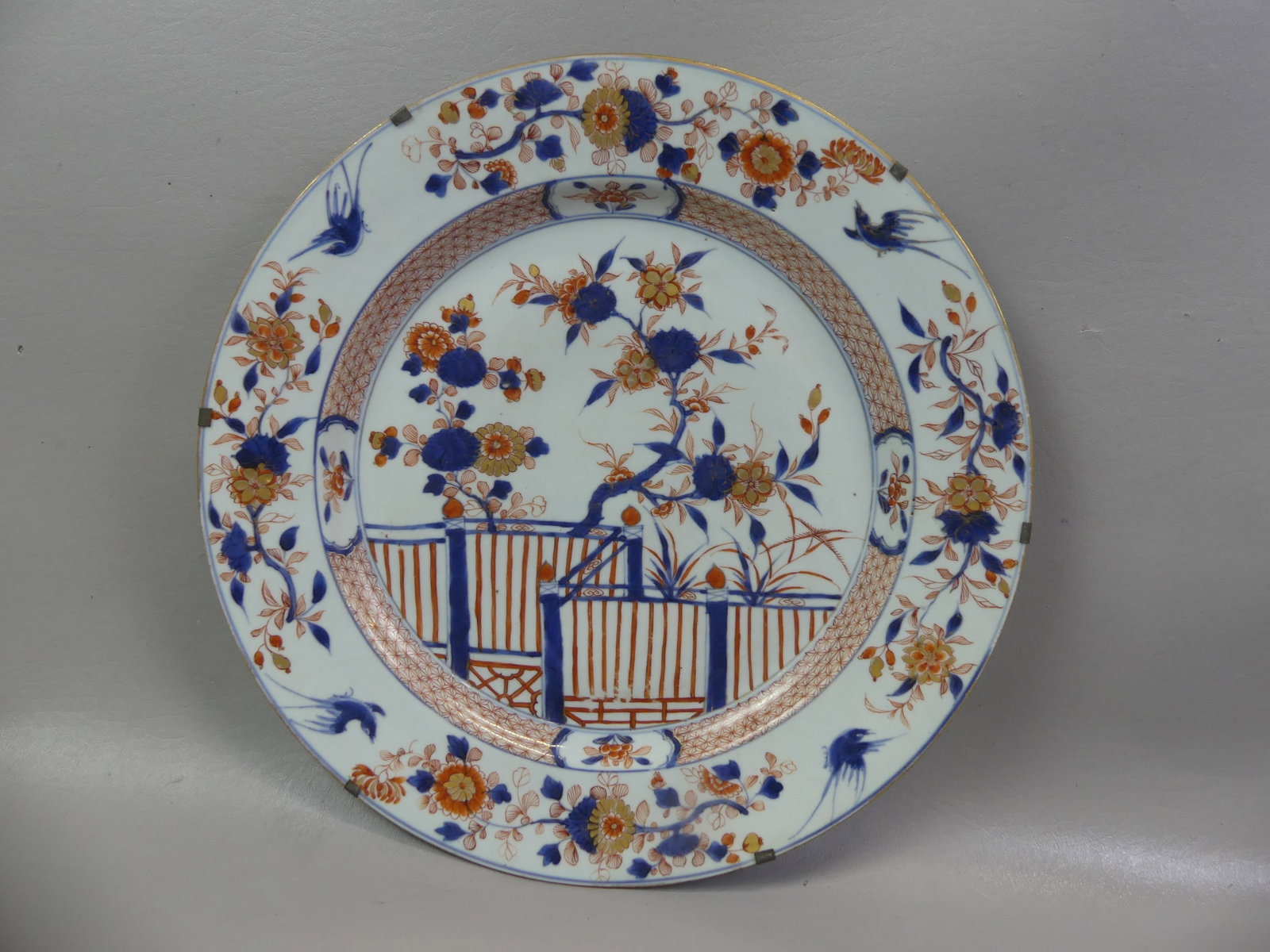 QIANLONG 15 IN. CHINESE CHARGER - VERANDA: 18th century large Qianlong charger in iron-red, gold and blue decoration depicting a veranda and flowers. 15.5 in diameter. VG condition with one tiny chip on rim.