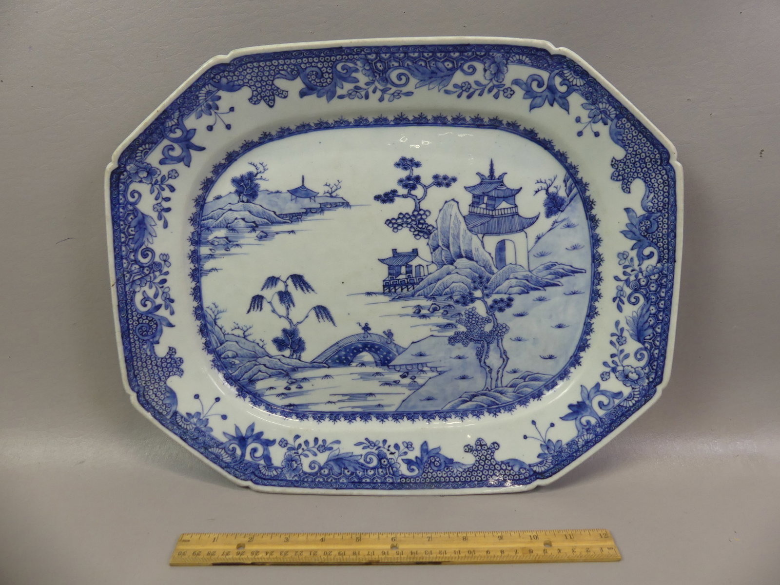 QIANLONG CHINESE BLUE PLATTER - TEMPLES: Fine 18th century Chinese Export Qianlong blue and white platter with shaped rim and decoration of temples on the water. 16.5 x 13.5 in. VG condition, no flaws.
