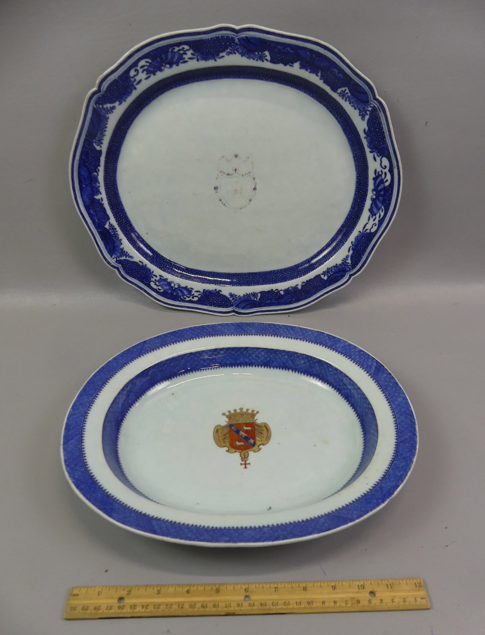 2 CHINESE 18TH C. ARMORIAL PLATTERS: Lot of 2 Chinese Qianlong armorial platters: deep platter or shallow bowl with armorial in center, 3 in hairline, 14.5 x 2 in deep; and 17.5 x 14.5 in armorial platter with shaped rim and butterfly de