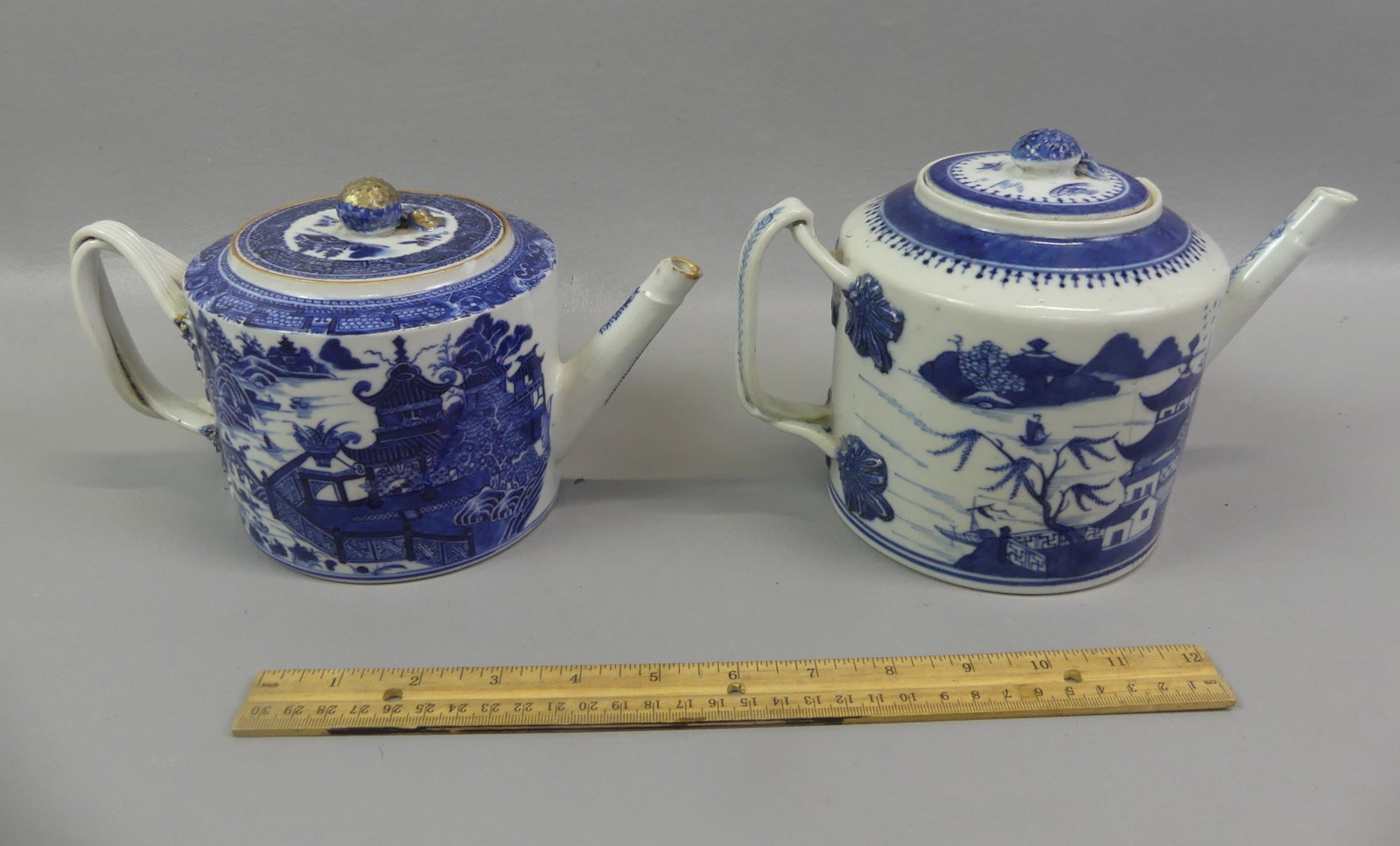 2 ANTIQUE CHINESE EXPORT DRUM TEAPOTS: Two Chinese Export blue and white drum-form teapots to 5 in tall circa early/mid 1800's: Canton with temples (ageline/chip on rim); and rich cobalt blue pot (couple internal hairlines, minor