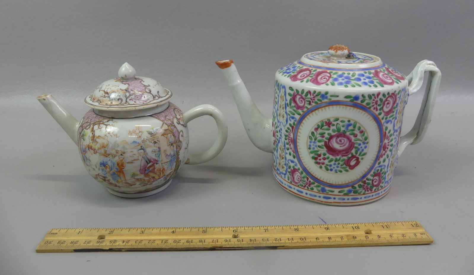 2 ANTIQUE CHINESE EXPORT TEAPOTS: Two Chinese Export ceramic teapots to 5 in tall: 18th century bulbous with fine genre decoration (repaired lid/flake on rim); and 19th century drum-form pot with colorful floral design (ageline on