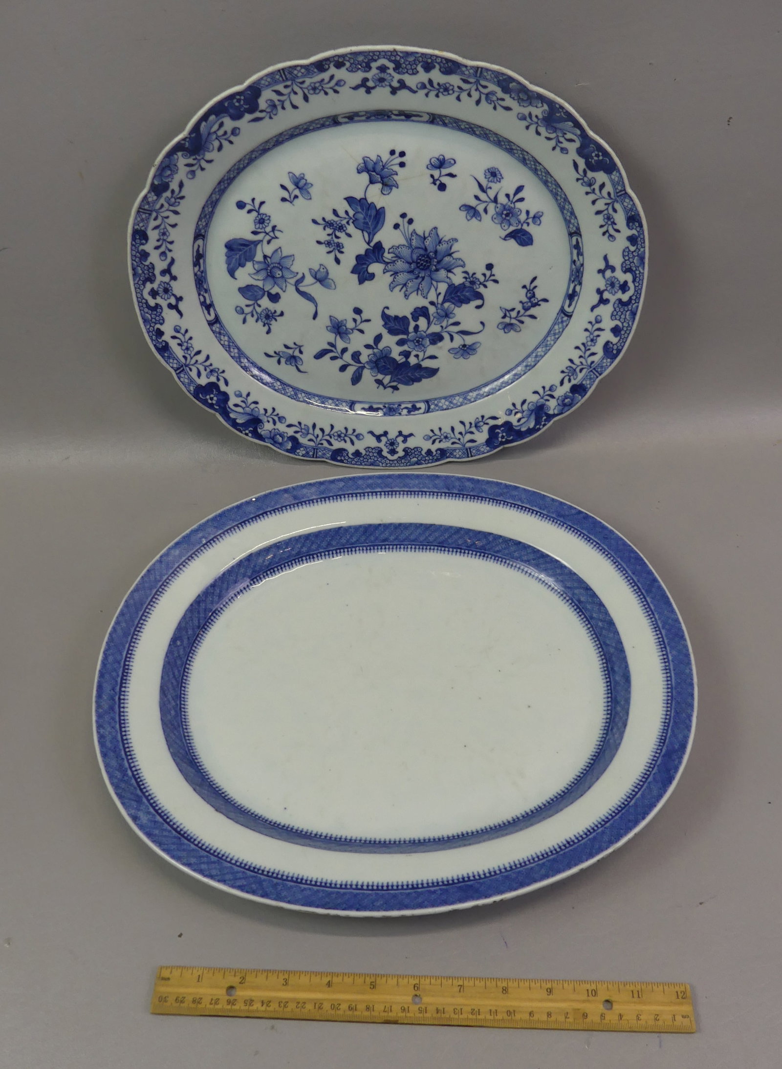 2 CHINESE QIANLONG PLATTERS: Lot of 2 Chinese 18th century Qianlong large platters in good condition: 16 in x 13.5 in with double row of blue decoration (minor edge roughness); and 15 x 13 in platter with floral decoration