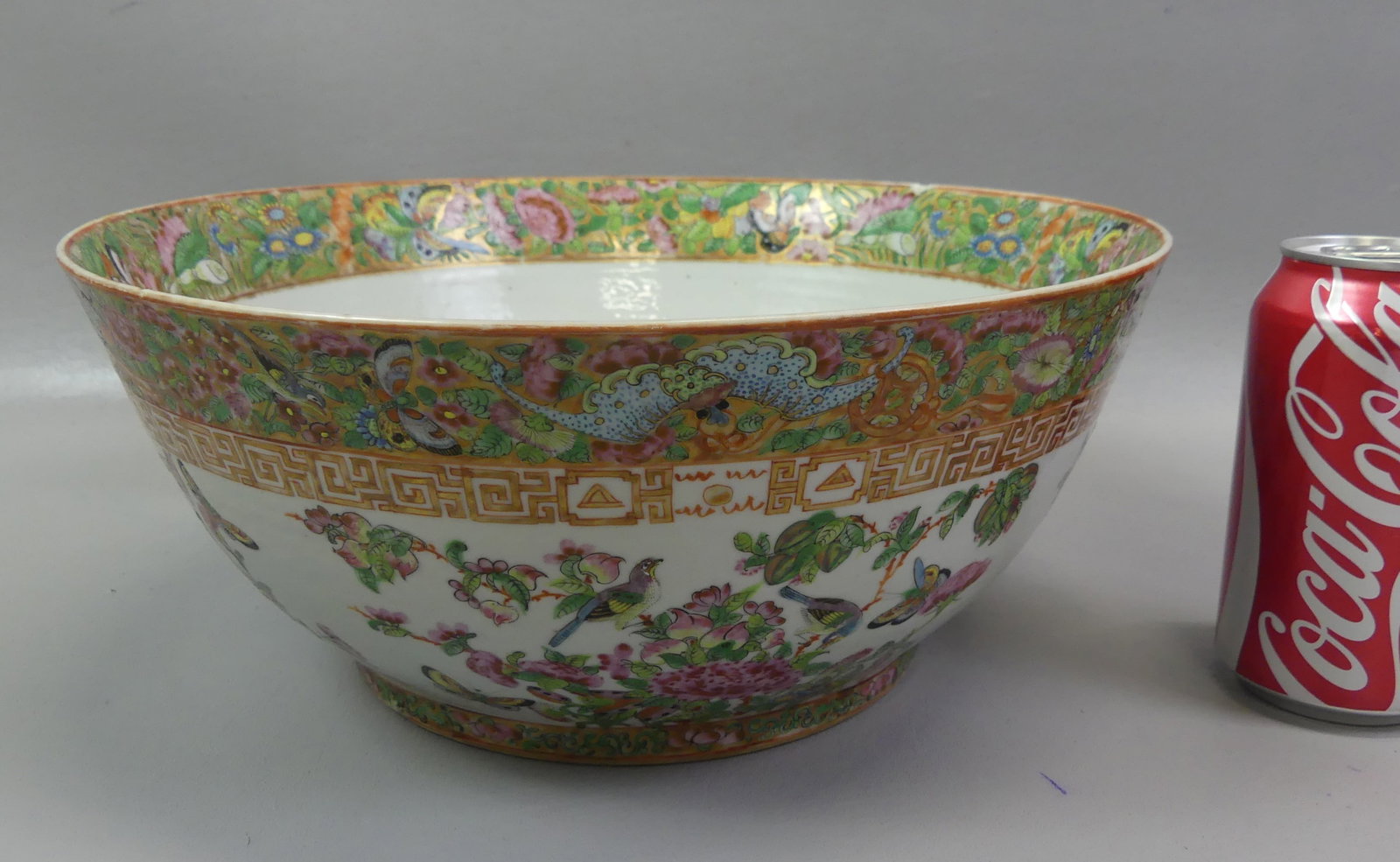 19TH C. CHINESE FAMILLE ROSE PUNCH BOWL: 19th century Chinese Export Famille Rose punch bowl with decoration of birds, flowers, butterflies, symbols. 11 x 5 in deep. Has light spider hairline on base and couple small rim chips.