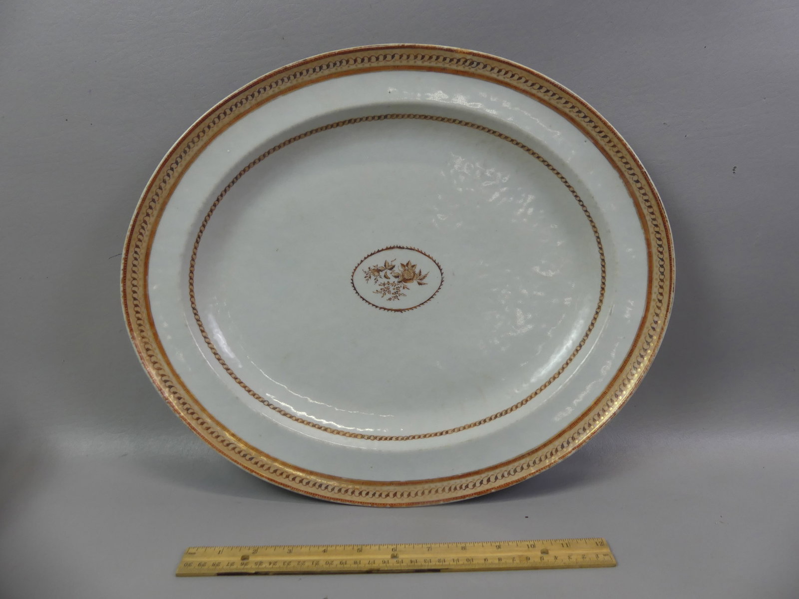 LARGE CHINESE QIANLONG PLATTER: Large 18th century Chinese Qianlong period oval serving platter in rust and gold colors and center painted floral medallion. 17.5 x 14.5 in. Excellent condition, no flaws. Circa 1780.