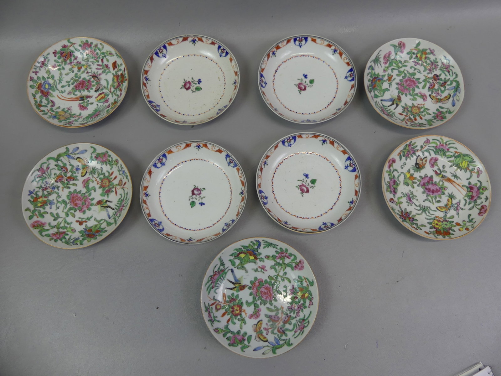 9 ANTIQUE CHINESE BOWLS: 2 sets of Chinese shallow bowls or saucers to 6 in diameter: set five 19th century Famille Rose with birds, butterflies, and flowers (vg); and set four 18th century with roses etc (2 minor hairlines).