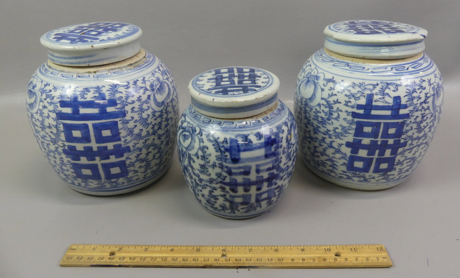 3 CHINESE CANTON GINGER JARS: Group of three 19th century Chinese Canton covered ginger jars with similar floral and Double Happiness symbols. From 5.5 to 7 in tall. All VG condition.
