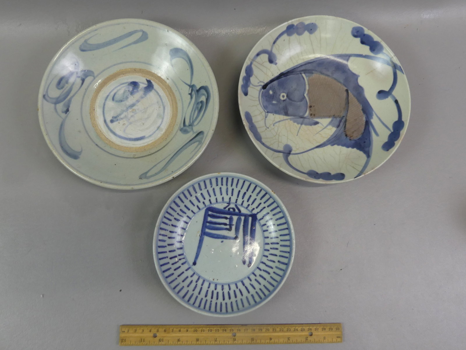 3 ANTIQUE CHINESE BOWLS: Lot 3 antique Chinese ceramic bowls: pale celadon with koi fish (signed), 10 x 2 inches, hairline/crazing to surface; 7.5 in plate with picket design (foot rim chip); and 10 x 2 in with blue designs