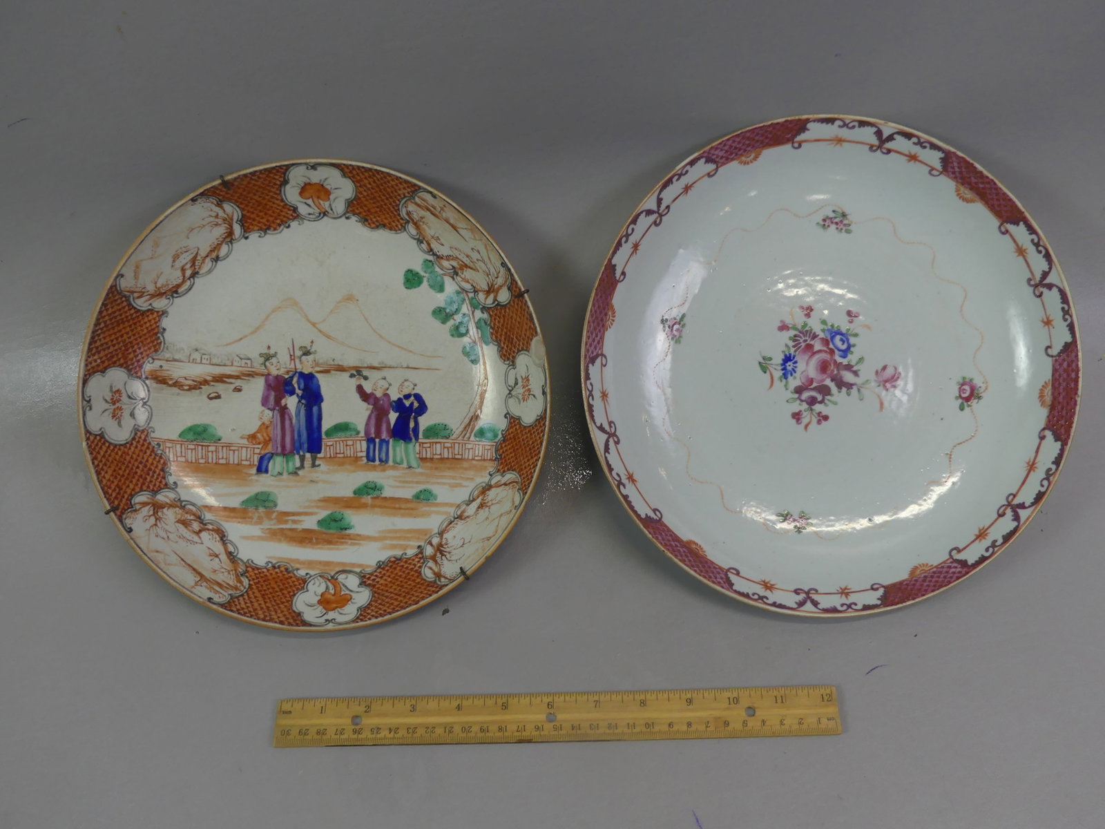 2 CHINESE QIANLONG SHALLOW BOWLS: Lot 2 Chinese 18th century Qianlong large, shallow bowls: one with genre scene with 4 figures by mountain lake and floral rim, 10.5 x 2 in (1 rim chip o/w good); and 11 x 2 inch floral with raised