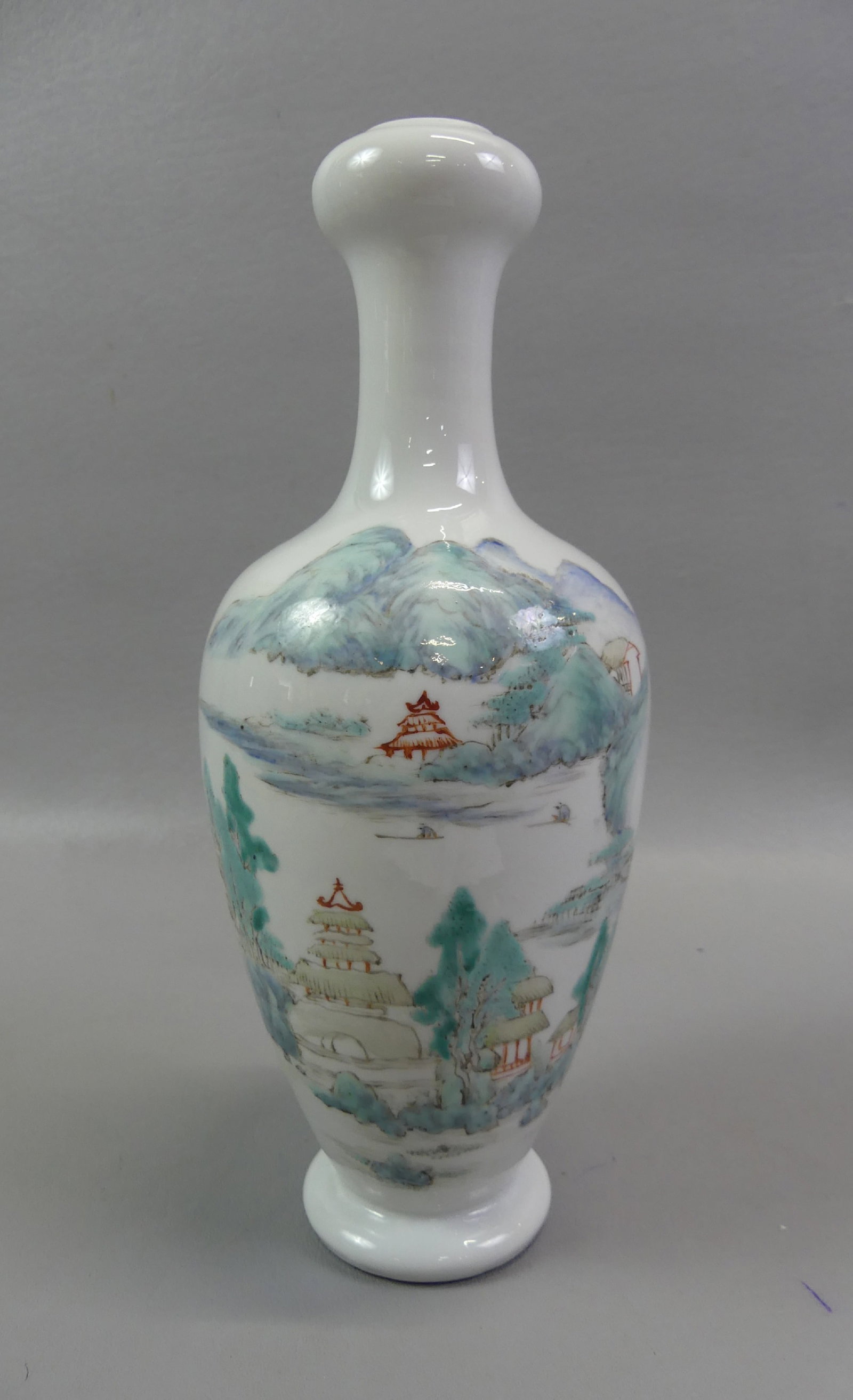 CHINESE FAMILLE ROSE VASE - TEMPLES: Antique Chinese Famille Rose decorated vase with narrow neck and temples in mountains. 11 in tall. Red seal mark on underside.