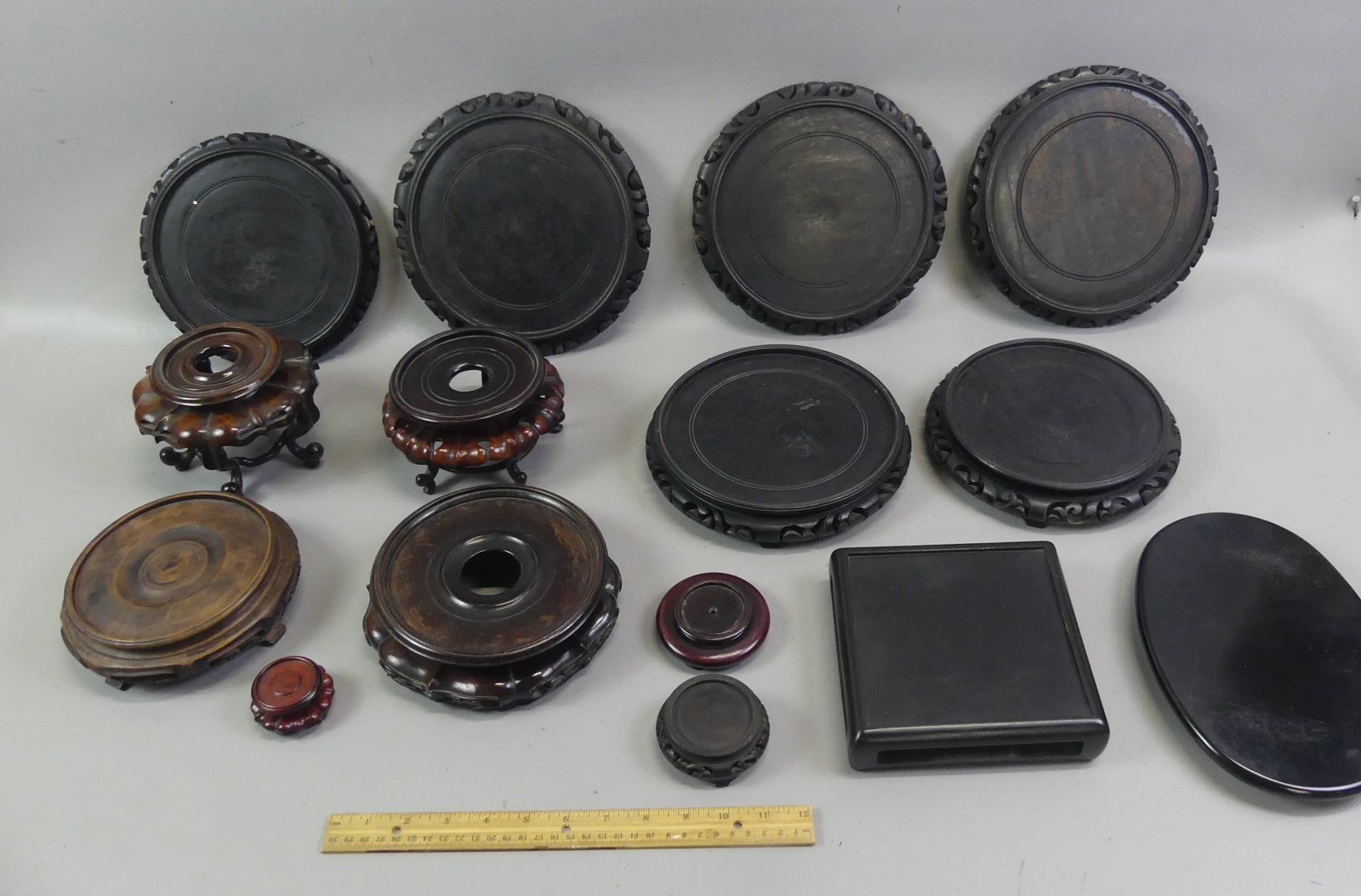 15 OLD CHINESE CARVED WOOD BASES: Lot 15 assorted old Chinese / Asian carved wood bases from 1.5 to 7.5 in diameter (interior size).
