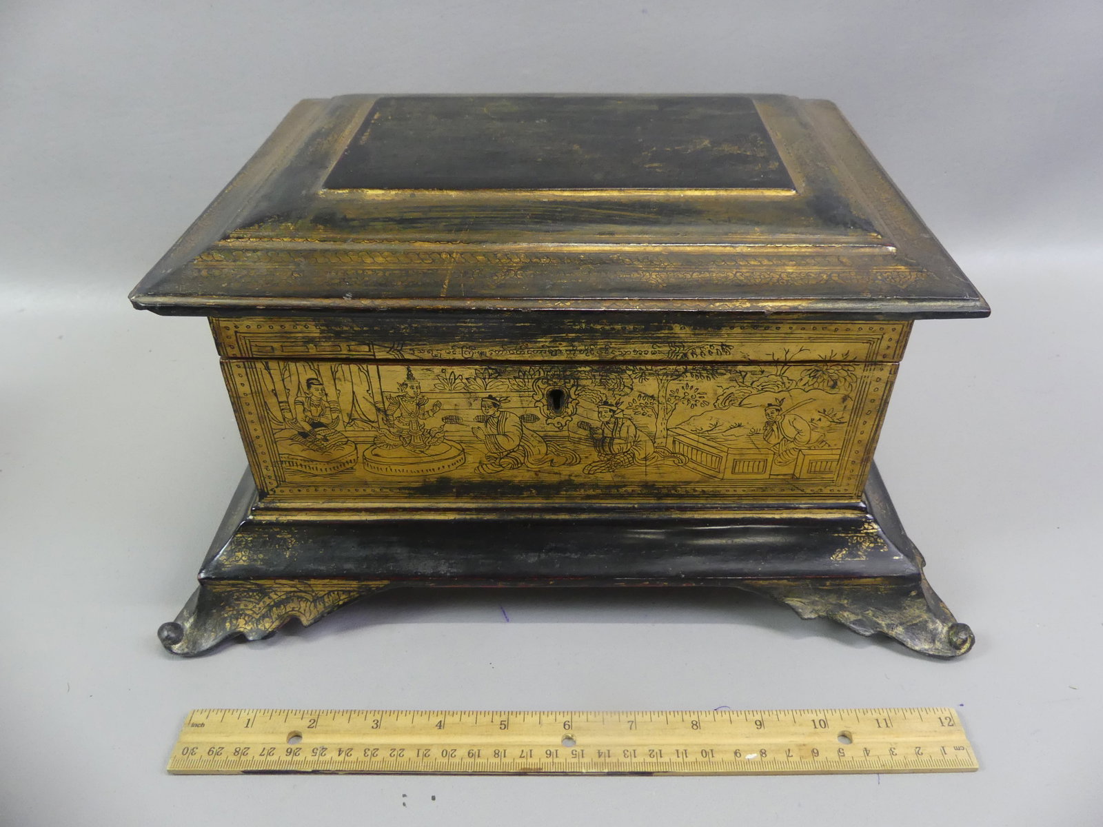 ANTIQUE BURMESE SHWEZAWA BOX: 19th century gilt and black lacquered wood lift-top Shwezawa box from Burma. It is decorated with genre scenes. 14 x 7 x 10 inches. Good overall