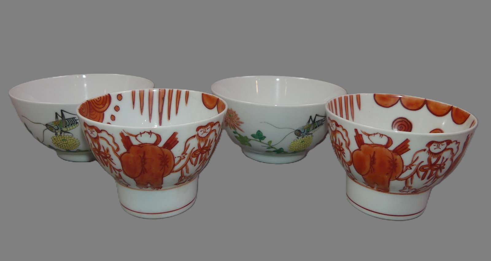 2 PAIR CHINESE PORCELAIN CUPS: 2 pairs of antique Chinese porcelain cups: pair footed with iron-red painted decoration with several figures and god riding a crane, 3.5 in; and pair decorated with flowers and grasshoppers, 4.5 in di