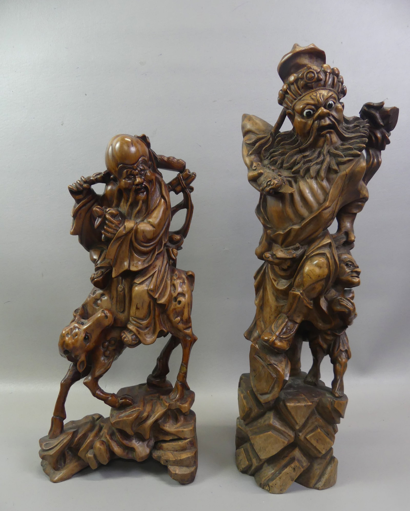 2 LARGE JAPANESE CARVED FIGURES: Lot of 2 large carved wood Japanese sculpture, from 18 to 23 in respectively: Scholar riding a oxen (repair to legs); and warrior pulling child by the hair (has glass eyes). Circa late 1800's.