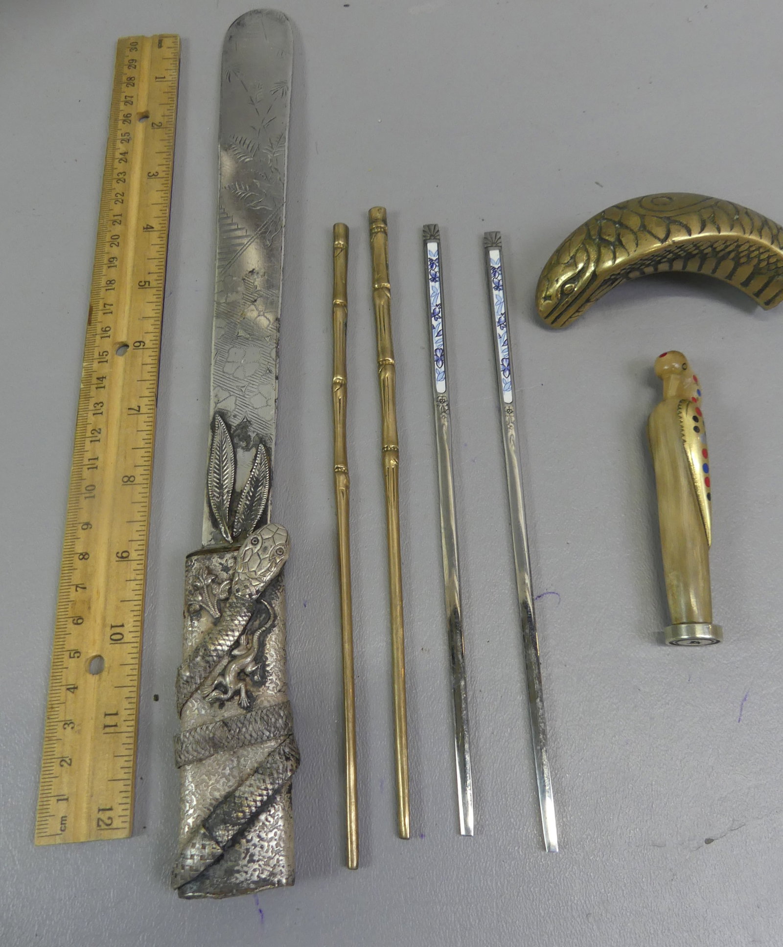 ASSORTED MOSTLY ASIAN ITEMS: Estate lof of mostly Asian items: 3 inch inlaid horn F stamp; 13 inch silver plated Japanese letter opener with snake or lizard; 2 pairs of chopsticks; brass snake-form cane handle.