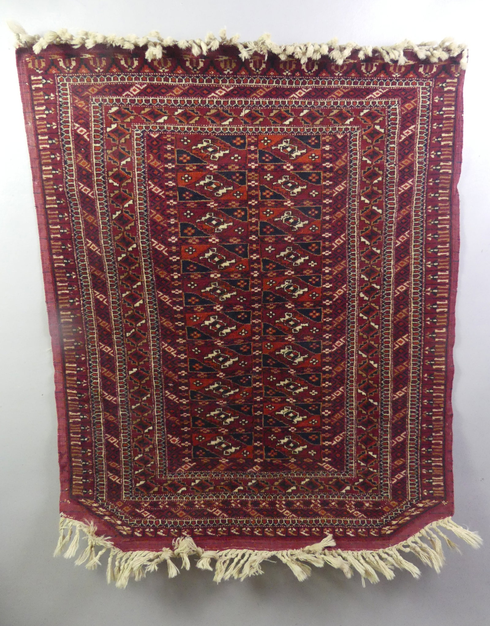 ANTIQUE TURKOMAN BALUCH RUG: Antique Turkoman Baluch or Bokhara scatter rug / camel trapping with angled corners on one end. 2 ft 8 in x 3 ft 4 in. Good condition.