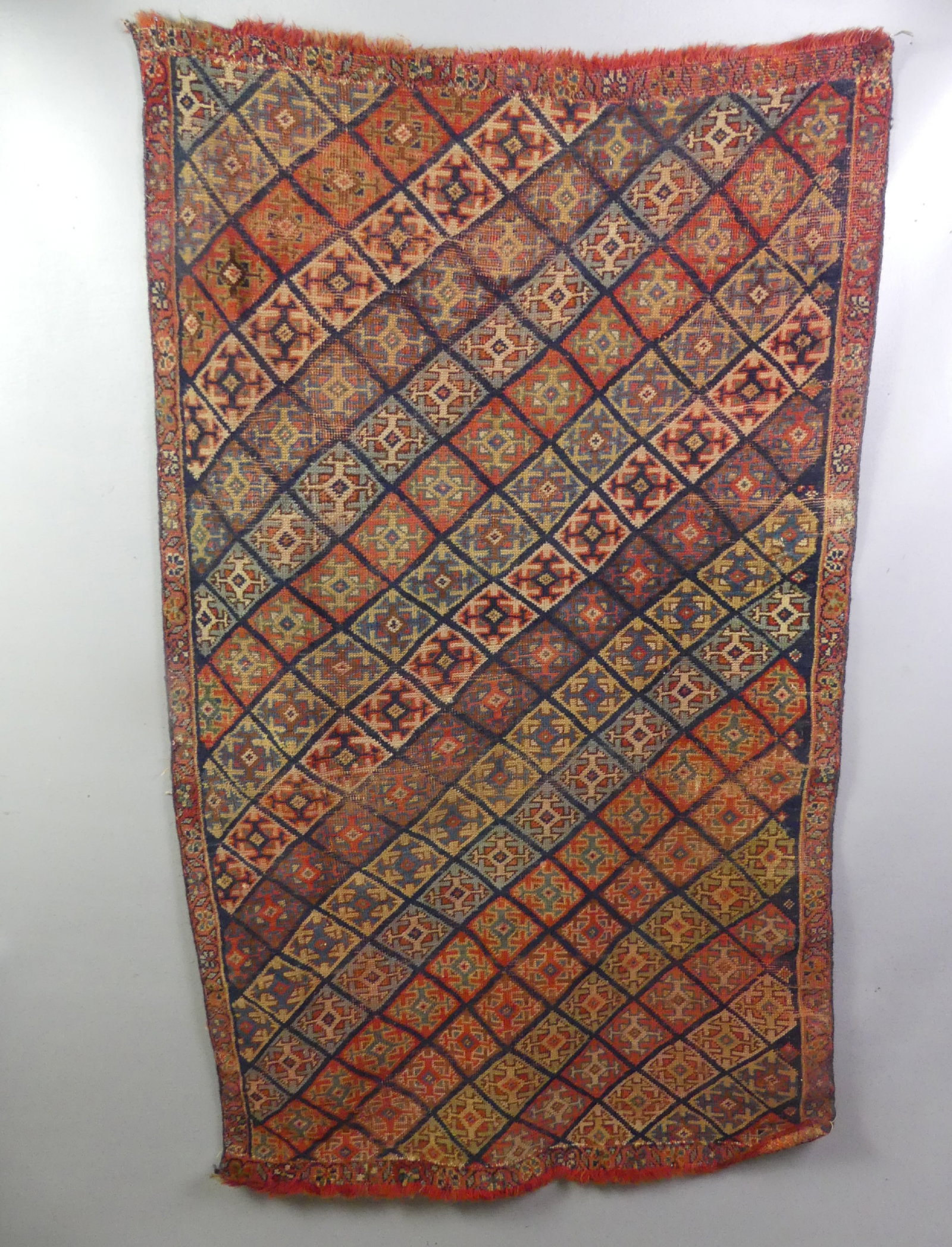 ANTIQUE LORI DIAMOND RUG: Antique Lori scatter rug in colorful diamond pattern, 2 ft 6 in x 4 ft. Ends appear to have been shortened, otherwise good.
