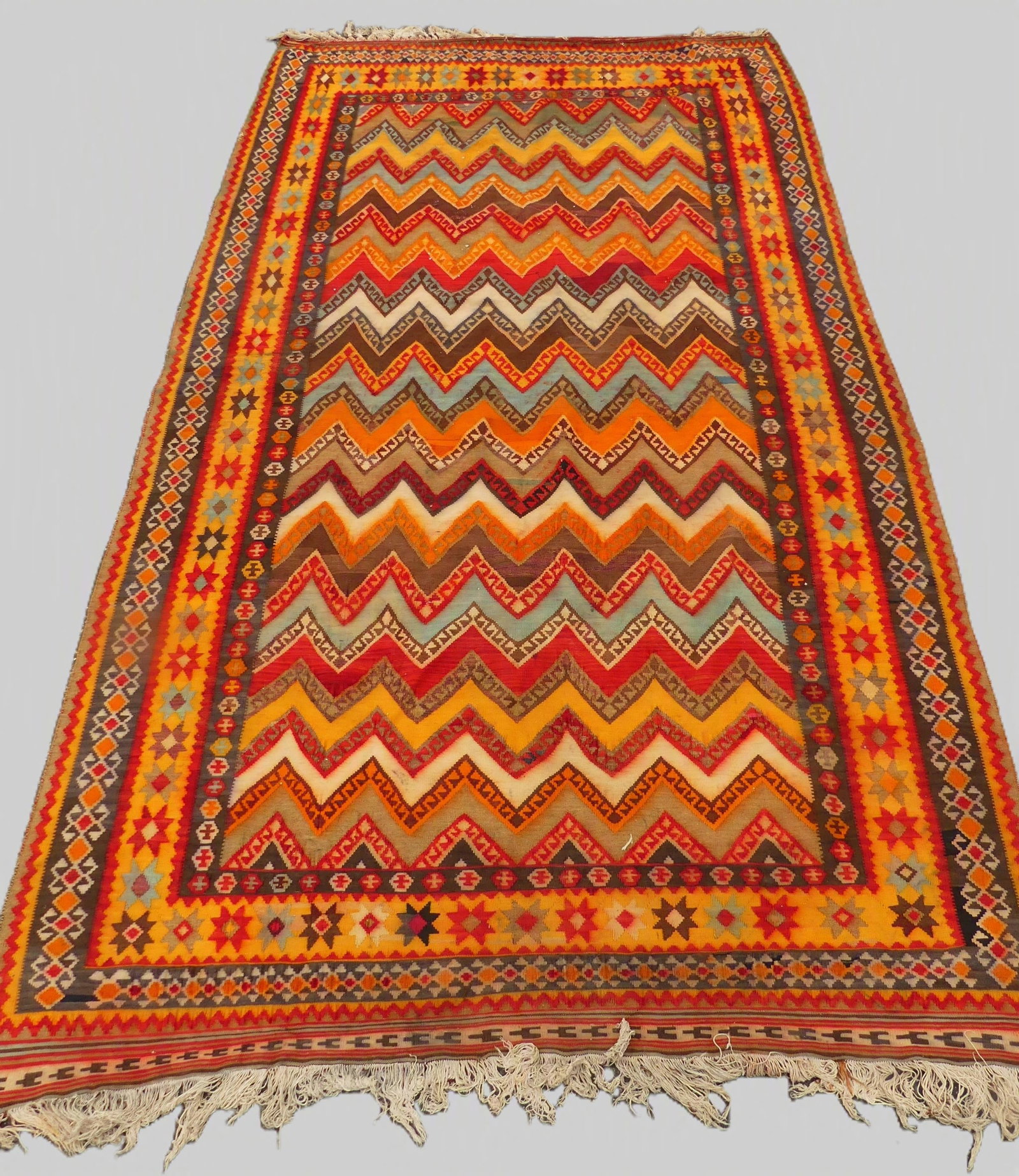 ANTIQUE KILIM RUG - ZIG ZAG PATTERN: Antique colorful Turkish Kilim rug with zig-zag design and stars. 5 ft 4 in x 9 ft 8 inches. Good condition.