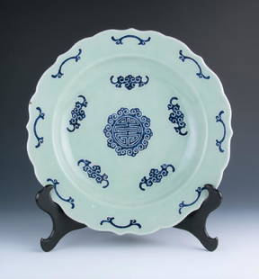 A Large Celadon Plate: A large celadon plate, the exterior painted with shou character in the centre, the base marked with six-character Qianlong seal in blue, diameter 37 cm