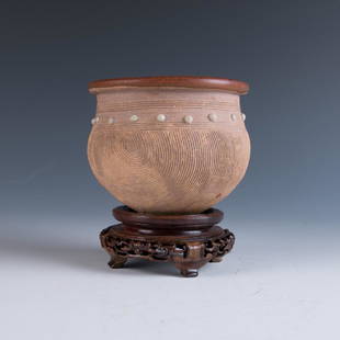 Gangzhouyao Measuring Jar, Song Dynasty: A Gangzhouyao measuring jar, of globular body standing on a flat base and with combed decoration on the unglazed brown body, rising to the wide neck with horizontal combed bands enclosing a bank of th