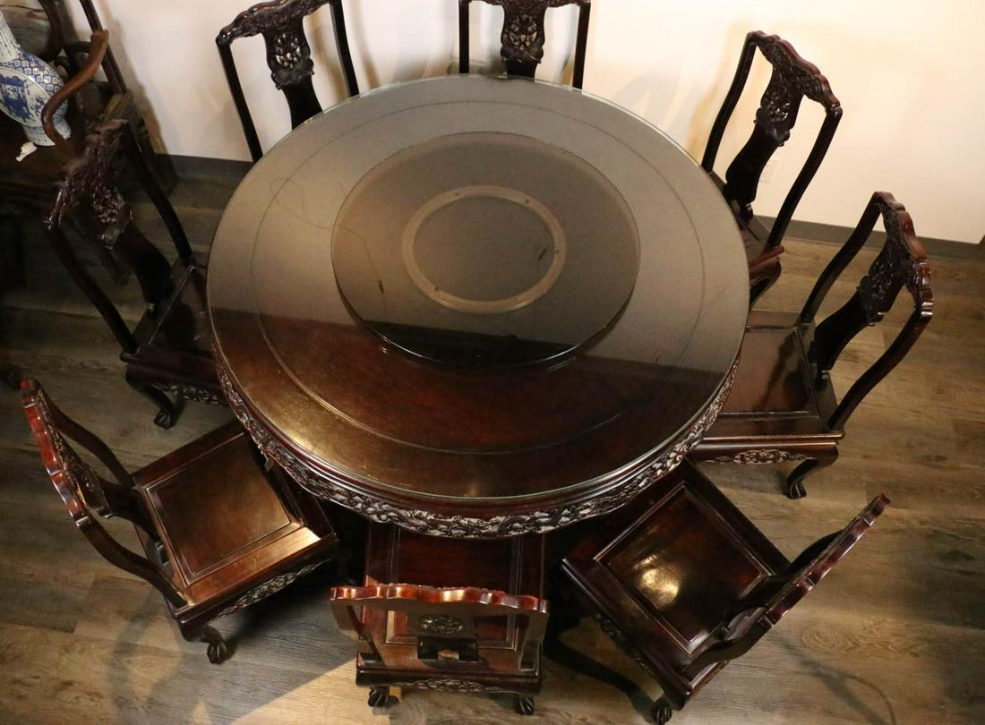 A HARDWOOD DINING TABLE SET: the table accompanied by eight chairs. Table: H: 78cm without glass. D: 133cm, Chair: H: 94cm