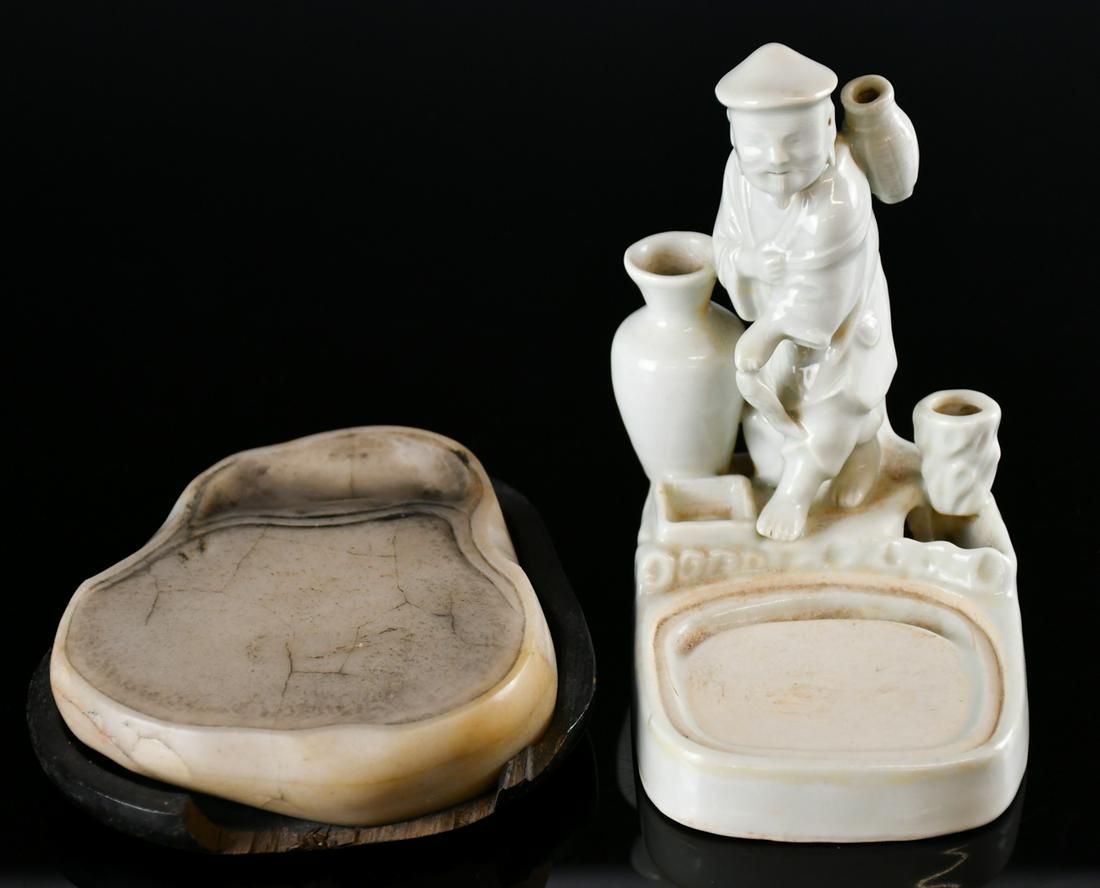 Two Ink Stones: The first made in stone of oval shape, in pale color. The second made in porcelain, depicting a fisherman with fish on hand beside his fishing tools. Largest L: 16cm. 硯台一組&