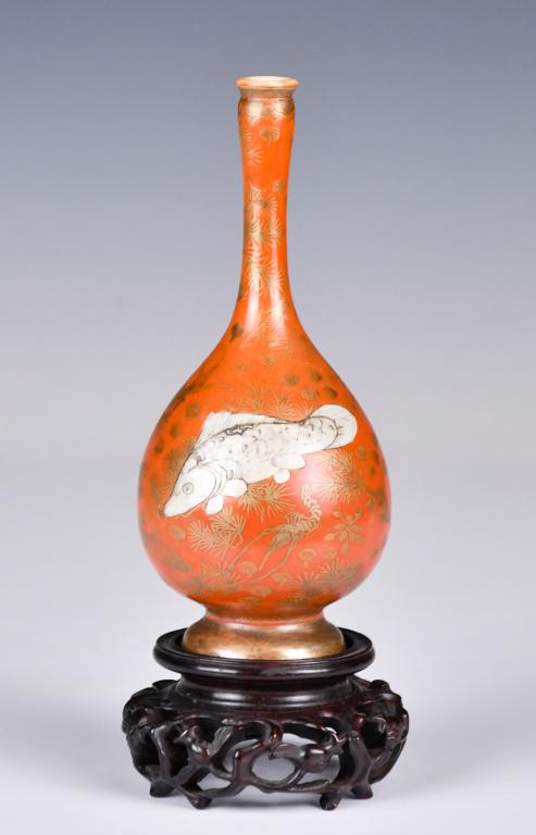An Iron Red Ground Gilt Fish Bottle w/Stand: A pear shape body supported by a tapered foot to a slender neck, exterior painted in gold with fishes and seaweed against the iron red ground, a large white fish at the center of each side of the body