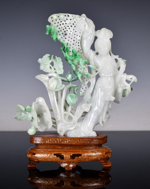 A Jade Figural Carving with Stand 1950-70s: 建國期 玉雕擺件連座 Finely carved from an opaque white jade stone with green inclusions, of a fairy fishing among a lotus pond. H: 15.1cm