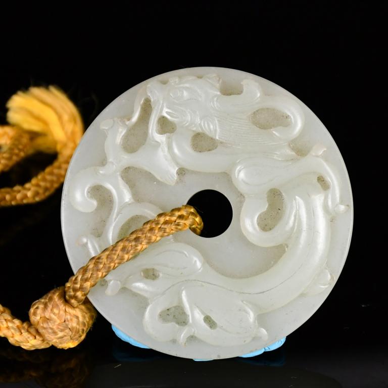 A Carved White Jade Archaistic 'Chilong' Bi Disc, Ming (1 of 6)
