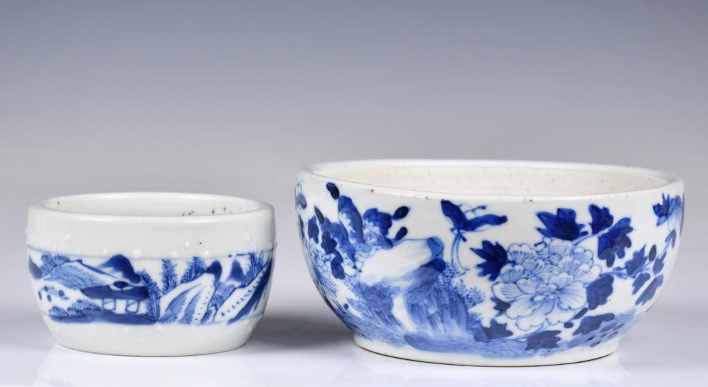 A Group of 2 Blue & White Water Pots: The larger one of the sides gentely round down to a flat base, painted to the exterior with flowers, D: 14.2cm. And the smaller one of a compressed globular shape, painted to the exterior with a regis