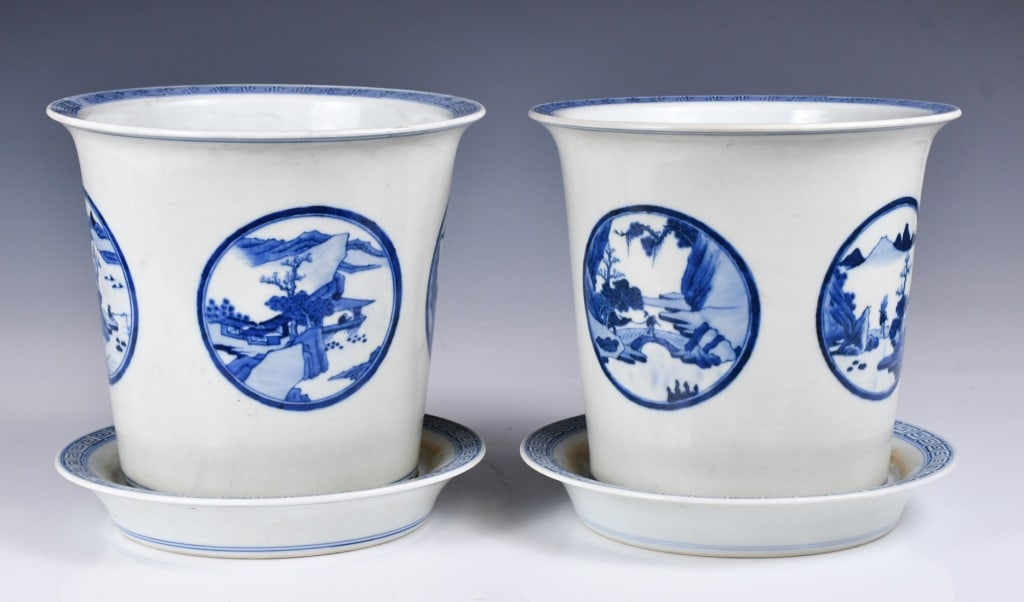 Pair of Blue & White Flowerpots w/Saucers Republic: The straight sides raising to an everted rim, each painted with different landscapes within round windows, and with fret motif decorated along the rims, H:18.8cm, D:21.2cm each Provenance: Estate of A
