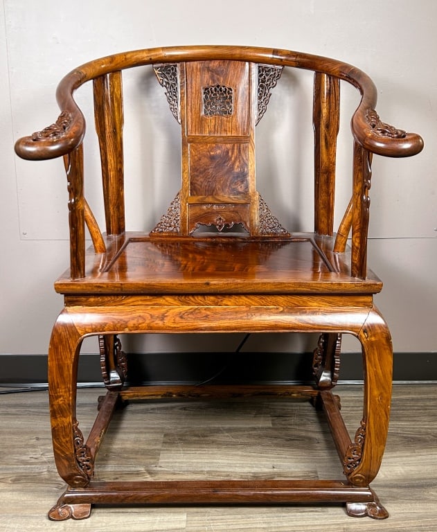 A Hardwood Carved Horseshoe Armchair 20thC: With slender crest rail continuing to form scrolled handgrips, with a splat carved with reticulated motifs, the hard cane seat with beaded flange brackets and apron, with a box stretcher. 72x75x99cm 2