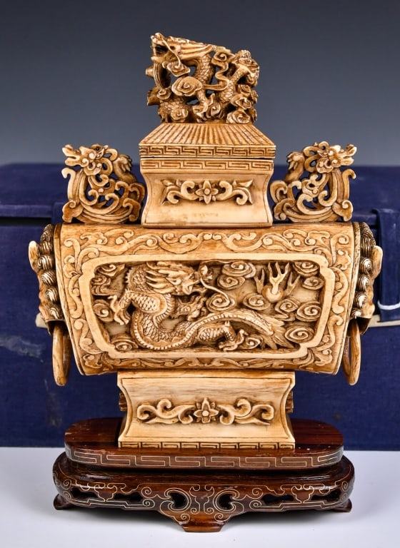 A Bone Carved Cover Vase w/Std & Box Republican: A bone carved compressed angular covered vase with high-relief dragon pattern decoration, L:15cm, H:18cm Condition report available upon request. Prospective buyers should inspect each lot to satisfy 