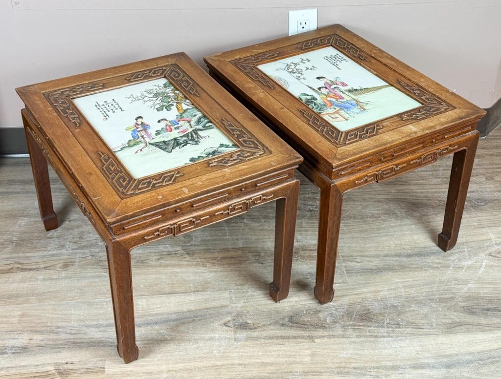 2 Famille Rose Plaque Hardwood Stools 1950-70s: Each of rectangular form, inset to the centre with a famille-rose porcelain plaque depicting two ladies in a courtyard setting, the plaque further inscribed. 55.9x42.6x40.7cm 