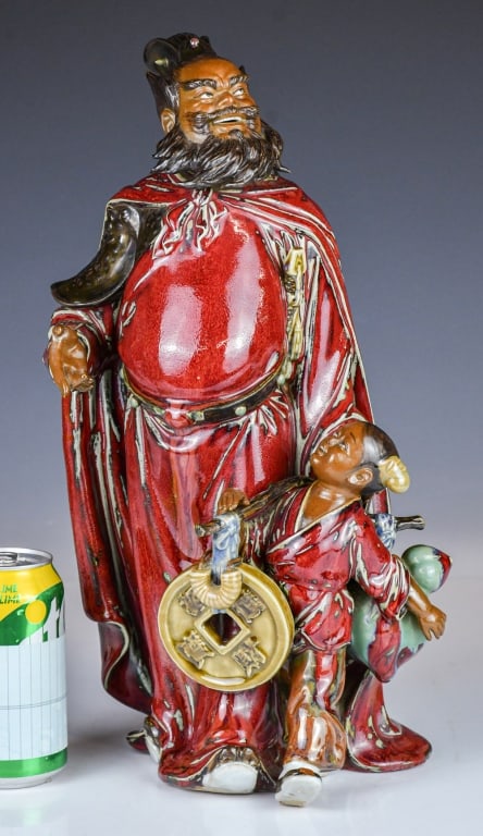 A Shiwan Kiln Figurine 20thC: Depicting a standing figure of Zhang Fei and a kid, marked with the artist's seal on the inner base. H:40cm 20世紀