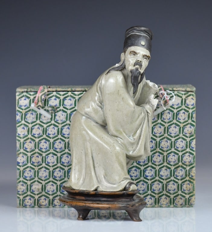 A Shiwan Porcelain Sculpture w/Pan Yushu Mk 19thC: Standing in a slightly stooped posture, his hands holding a scroll and wearing an official抯 cap, depicted with a moustache and pointed beard; with a mark on the bottom back. H: 20.3cm 
